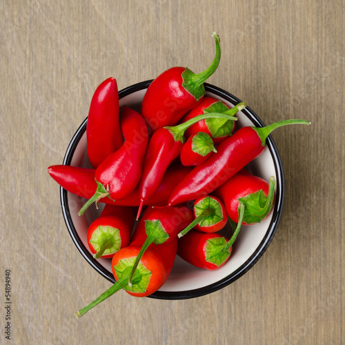 Photo: bowl of red chili peppers, top view bowl of red chili peppers, top view