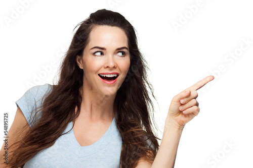 Photo: Beautiful woman pointing at copy-space Beautiful woman pointing at copy-space