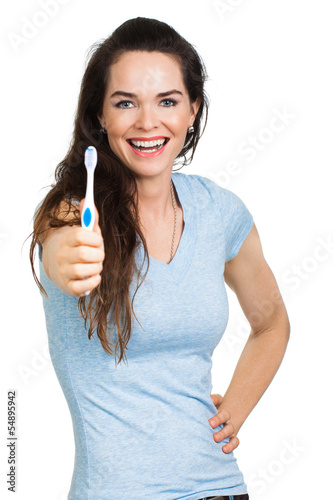 Photo: SMiling woman holding toothbrush SMiling woman holding toothbrush