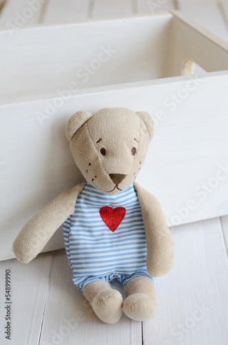 Photo: Little teddy bear on light background Little teddy bear on light background