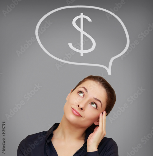 Photo: Business woman thinking about dollar currency on grey background Business woman thinking about dollar currency on grey background