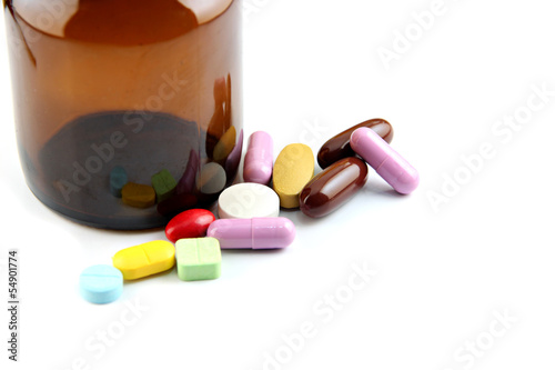 Photo: Pill of many color Beside the bottle. Pill of many color Beside the bottle.