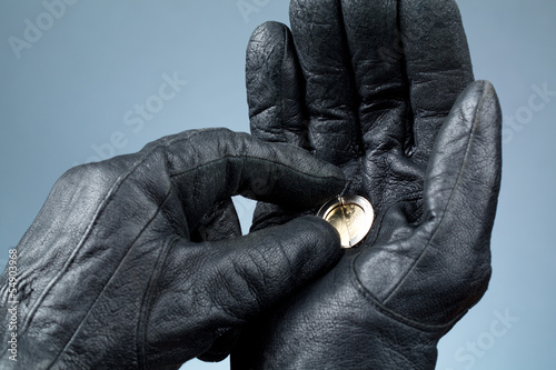 Photo: Hands with leather gloves holding money Hands with leather gloves holding money