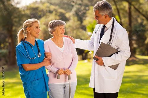 Photo: male doctor talking to recovering senior patient male doctor talking to recovering senior patient