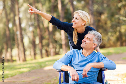Photo: loving mid age wife taking injured husband for a walk loving mid age wife taking injured husband for a walk