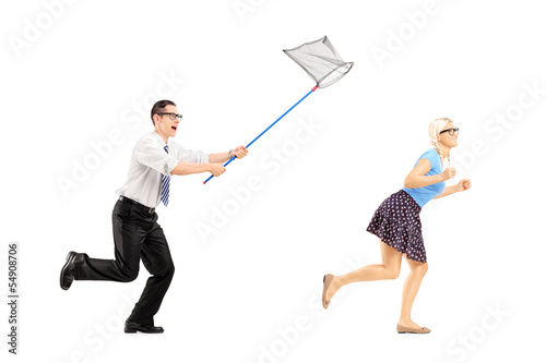 Photo: Full length portrait of a young woman trying to runaway from guy Full length portrait of a young woman trying to runaway from guy