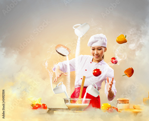 Photo: Asian female cooking with magic Asian female cooking with magic