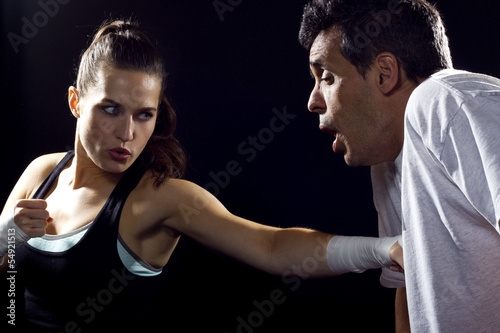 Photo: young fit woman fighting a man young fit woman fighting a man