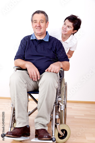 Photo: Woman pushing wheelchair Woman pushing wheelchair