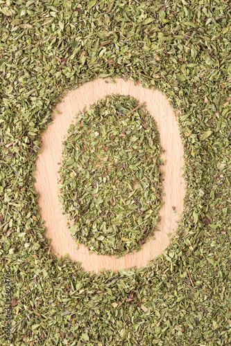 Photo: Letter O written with oregano Letter O written with oregano