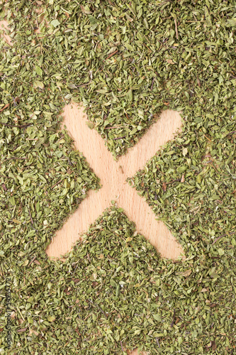 Photo: Letter X written with oregano Letter X written with oregano