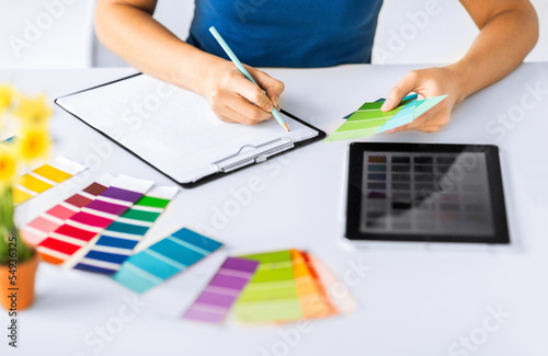 Photo: woman working with color samples for selection woman working with color samples for selection