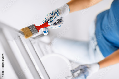Photo: woman with paintbrush and paint pot woman with paintbrush and paint pot
