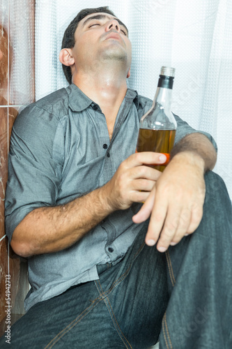 Photo: Drunk latin man sleeping on the toilet floor Drunk latin man sleeping on the toilet floor