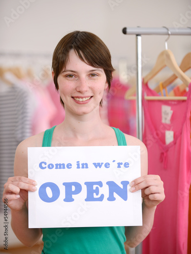 Photo: Store owner holding open sign Store owner holding open sign