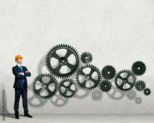 Photo: Businessman and mechanism elements Businessman and mechanism elements