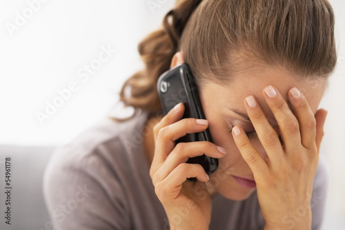 Photo: Stressed young woman talking mobile phone Stressed young woman talking mobile phone