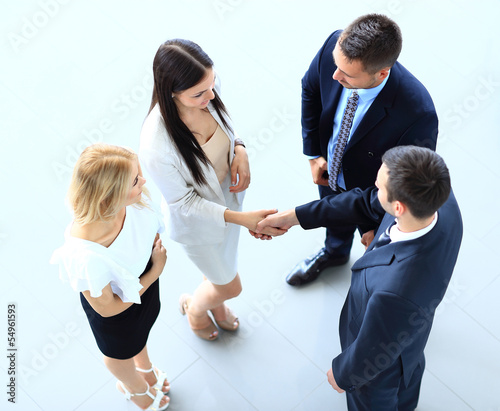 Photo: Full length image of two successful business men shaking hands Full length image of two successful business men shaking hands