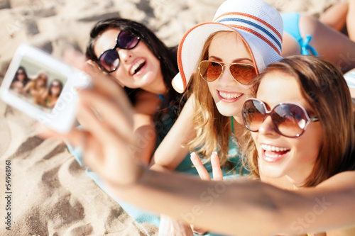 Photo: girls making self portrait on the beach girls making self portrait on the beach