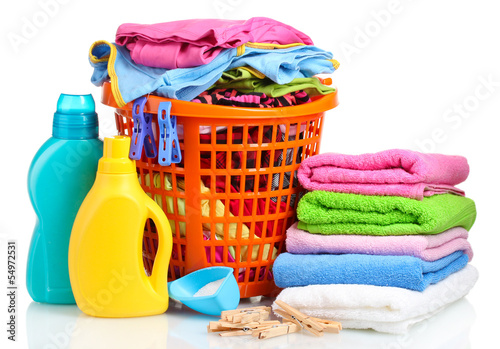 Photo: Clothes with detergent and washing powder in orange plastic Clothes with detergent and washing powder in orange plastic