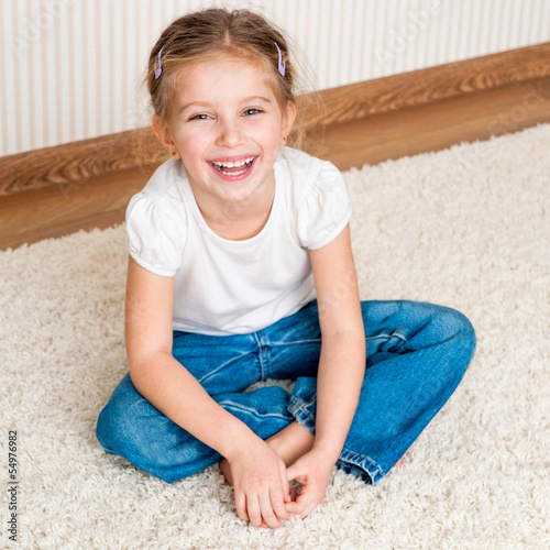 Photo: little girl sitting on the floor little girl sitting on the floor