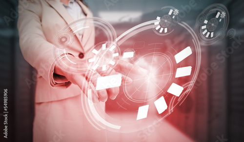 Photo: Businesswoman touching futuristic circle interface Businesswoman touching futuristic circle interface