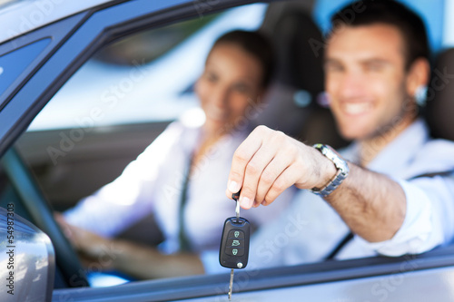 Photo: Young couple with keys to new car Young couple with keys to new car