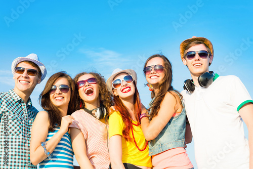 Photo: group of young people wearing sunglasses and hat group of young people wearing sunglasses and hat