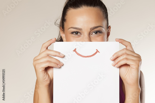 happy and smiling girl with a smile painted on paper