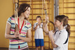 Photo: Deutschland, Emmering, Frau und Mädchen mit Gymnastikringen mit Jungen im Hintergrund Deutschland, Emmering, Frau und Mädchen mit Gymnastikringen mit Jungen im Hintergrund