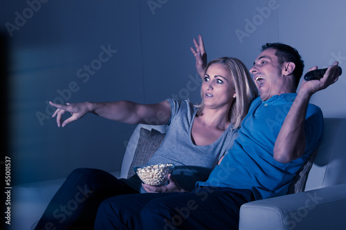 Photo: Scared Couple Watching Television Scared Couple Watching Television