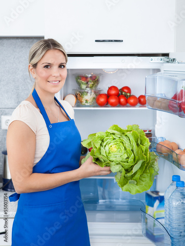 Photo: Woman In Apron Holding Bottle Woman In Apron Holding Bottle