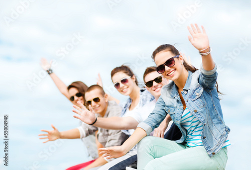 Photo: group of teenagers waving hands group of teenagers waving hands