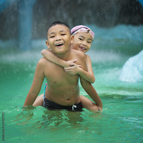 Photo: Happy Asian kids having fun at swimming pool Happy Asian kids having fun at swimming pool