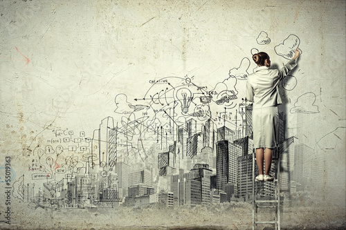 Photo: Businesswoman drawing on wall Businesswoman drawing on wall