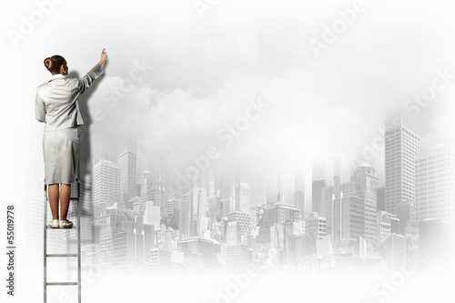 Photo: Businesswoman drawing on wall Businesswoman drawing on wall
