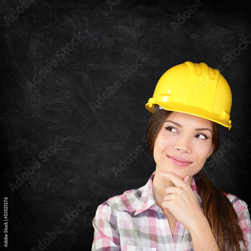 Photo: Construction worker woman on chalkboard texture Construction worker woman on chalkboard texture