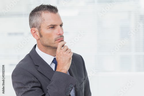 Photo: Pensive businessman looking away Pensive businessman looking away