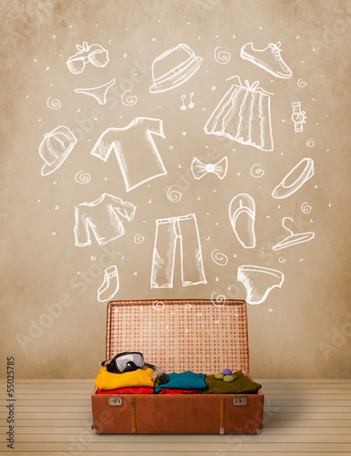Photo: Traveler luggage with hand drawn clothes and icons Traveler luggage with hand drawn clothes and icons