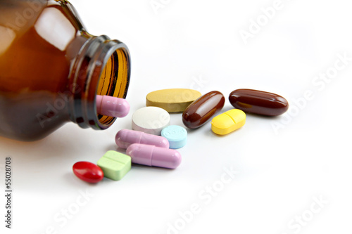 Photo: Pill of many color Beside the bottle. Pill of many color Beside the bottle.