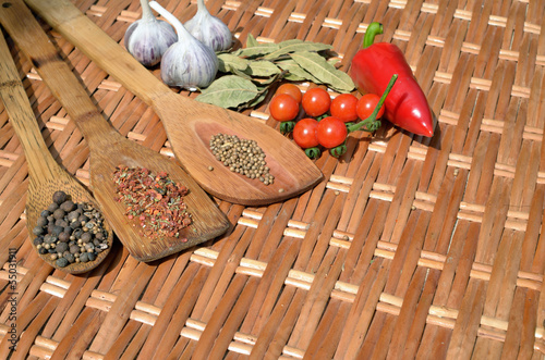 Photo: still life of of vegetables and spices on a wicker table still life of of vegetables and spices on a wicker table