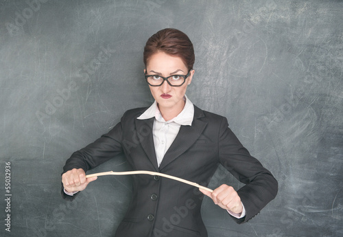 Photo: Angry teacher with wooden stick Angry teacher with wooden stick