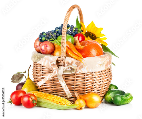 Photo: autumnal harvest vegetable and fruit in basket isolated on autumnal harvest vegetable and fruit in basket isolated on