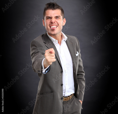 Photo: Businessman show popular gesture - fig Businessman show popular gesture - fig