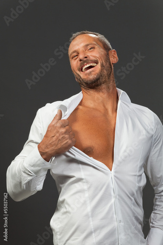 Photo: adult muscular man showing his chest adult muscular man showing his chest