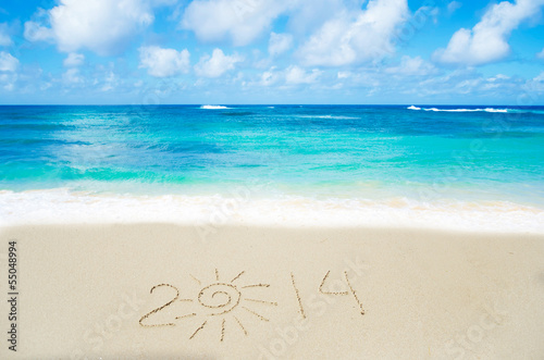 Photo: Number 2014 on the sand - holiday concept Number 2014 on the sand - holiday concept