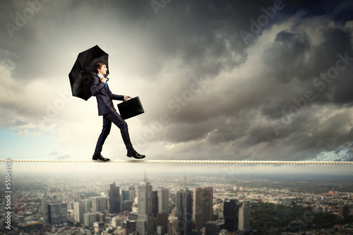 Photo: Businessman balancing on rope Businessman balancing on rope