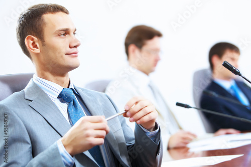 Photo: Three businesspeople at meeting Three businesspeople at meeting