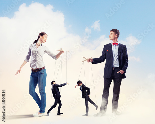 Photo: Businesspeople with marionettes Businesspeople with marionettes