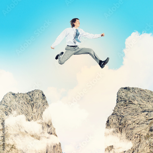 Photo: Businessman jumping over gap Businessman jumping over gap